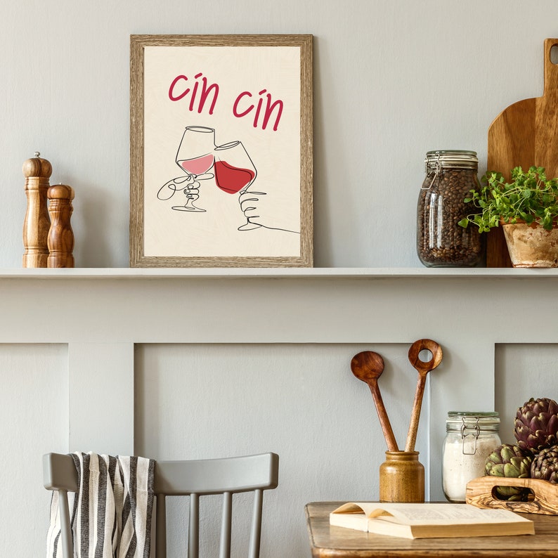 May include: A framed print with a minimalist line drawing of two wine glasses clinking together. The text "cin cin" is written in red above the glasses.