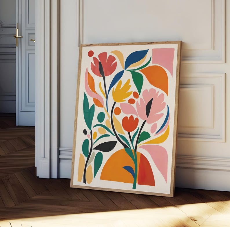 May include: A framed art print featuring a colorful floral design. The artwork showcases stylized flowers and leaves in shades of red, pink, orange, yellow, green, and blue against a cream background. The print is in a natural wood frame.