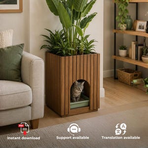 May include: A square wooden cat litter box enclosure featuring vertical slats and an arched front opening. A grey tabby cat sits inside the enclosure next to a light green litter tray. A large green potted plant sits on top of the wooden structure.