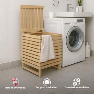 May include: A light-coloured wooden laundry hamper with a slatted design and a hinged lid. The square-shaped hamper features horizontal wooden slats on all four sides and a vertical slatted lid, with a white towel draped over the front edge.