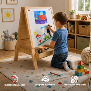 May include: A light-colored wooden A-frame easel with a white magnetic dry-erase board surface. The board features colorful child-drawn illustrations of a red ship, a house, and trees. A wooden tray holds colored markers and pencils.