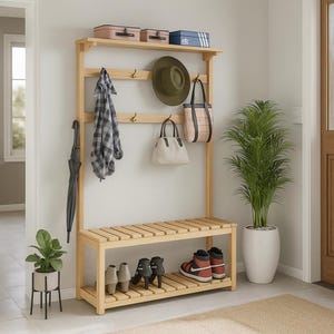 May include: A light wood entryway organizer with a bench, shoe rack, and coat rack. The rack holds a plaid shirt, a green hat, and two purses. A black umbrella and a potted plant are also visible.