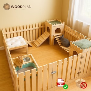 Peut inclure: Un clapier en bois clair avec une clôture, deux structures en forme de château avec des accents verts, une rampe et un petit lit avec un coussin blanc. Deux lapins sont à l'intérieur du clapier.