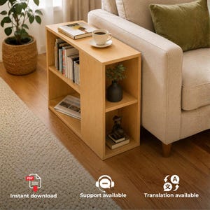 May include: A light wood side table with a rectangular top and two vertical storage sections. The top surface holds a book and a white coffee cup on a saucer. The left section contains multiple books, while the right section holds a small plant and a figurine.