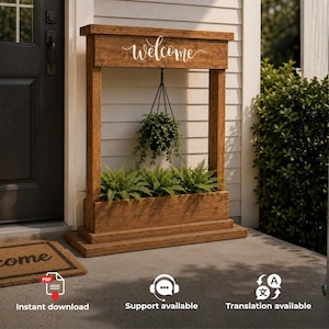 May include: A freestanding wooden porch planter with a rectangular base and a top header featuring the white script text "welcome". A hanging plant is suspended from the centre, while a row of green ferns fills the lower planter box.