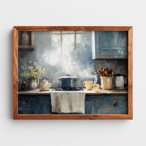 May include: A framed painting of a kitchen interior. A blue pot steams on a hob, with yellow cups and a teapot. A vase of flowers and wooden utensils are also visible. The painting has a soft, muted colour palette.