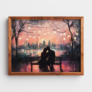 May include: A framed painting depicts a couple silhouetted on a bench, with a city skyline and string lights in the background. The artwork features a warm color palette of pinks, oranges, and purples, creating a romantic and serene atmosphere. The frame is made of wood.