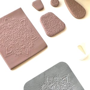 May include: A selection of craft tools, including clay and metal pieces. The clay items, in various shapes like rectangles and circles, feature a detailed mandala pattern. A metal piece with a mandala design is also visible.
