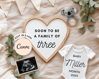 May include: A heart-shaped wooden sign with the text "SOON TO BE A FAMILY OF three" and a baby onesie that says "BABY Miller MONTH 20XX". A small ultrasound image and a koala rattle are also present.