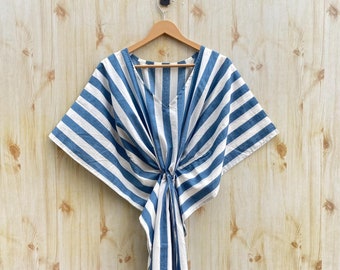 May include: A blue and white striped kaftan dress with a V-neck and a tie at the waist.