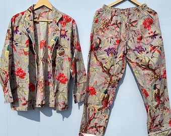 May include: A gray and white pajama set with a floral print featuring birds and flowers. The top has a button-up front and long sleeves. The pants have an elastic waistband.