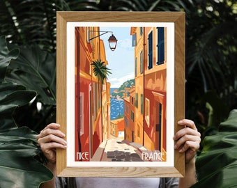 May include: A vintage travel poster featuring a colorful illustration of a narrow street in Nice, France. The street is lined with buildings in shades of orange, yellow, and red, and there is a glimpse of the Mediterranean Sea in the distance. The text "NICE" and "FRANCE" is printed at the bottom of the poster.