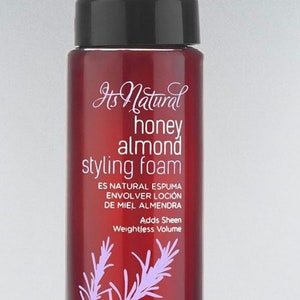 May include: A maroon bottle of Srifluance honey almond styling foam with a white pump and cap. The bottle has a purple floral design and text that reads "Its Natural honey almond styling foam". The bottle contains 8 fl oz.