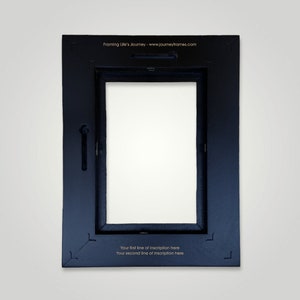 May include: Black picture frame with a white mat and a space for a photo or artwork. The frame has a gold inscription on the bottom that reads "Your first line of inscription here Your second line of inscription here".