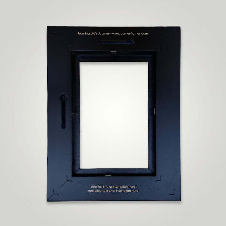 May include: Black picture frame with a white mat and a space for a photo or artwork. The frame has a gold inscription on the bottom that reads "Your first line of inscription here Your second line of inscription here".