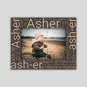 May include: A brown word cloud frame with the name "Asher" repeated many times. The frame surrounds a photo of a young child sitting on a sandy beach holding a stick.