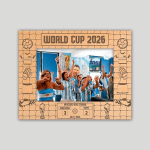 May include: A rectangular wooden photo frame featuring the text WORLD CUP 2026 at the top and a scoreboard at the bottom showing Argentina 3 and Egypt 2 for July 7 2026. The frame is decorated with engraved soccer balls, jerseys, and trophies.