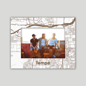 May include: A photo frame featuring a black and white map of Tempe, Arizona with a photo of three friends sitting on a wall. The photo frame has a white border and the city name "Tempe" is printed in brown text at the bottom.