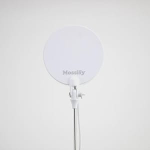 May include: A white, circular light with the word "Mossify" printed on it. The light is attached to a white stand with a silver pole. The light is designed for use in photography or video production.