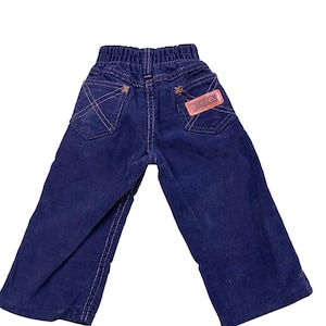 Vintage 70s Tough Skins navy blue corduroy pants. Made to the USA. Tagged as a 2T, measures more as a 12 to 18 months.