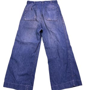 Vintage U.S. Navy Seafarer button fly denim bell bottom stenciled dungarees. USA Measures as a 26x24.