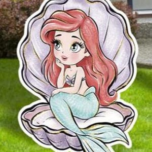 May include: A cartoon illustration of a mermaid with red hair and a teal tail, seated inside a seashell. The mermaid is wearing a seashell top and is resting her chin on her hand. The seashell is white and purple.