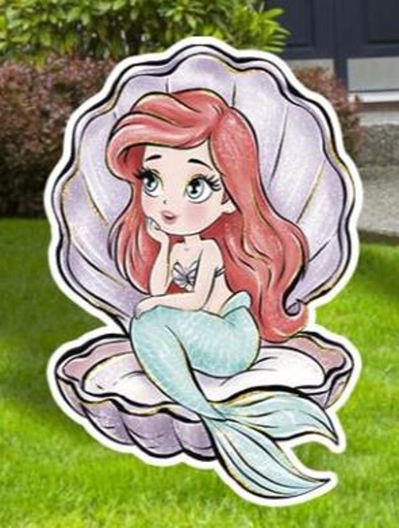 May include: A cartoon illustration of a mermaid with red hair and a teal tail, seated inside a seashell. The mermaid is wearing a seashell top and is resting her chin on her hand. The seashell is white and purple.