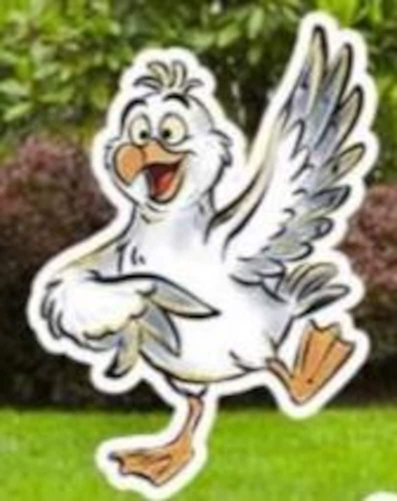 May include: A cartoon illustration of a white seagull with a yellow beak and feet, and gray wing feathers. The seagull is smiling and appears to be dancing on a green lawn, with a blurred green background of bushes and trees.