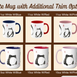 May include: Six white ceramic mugs with a black ink illustration of a frog. The mugs are available in three sizes: 11oz, 15oz. Each mug has a colored rim and handle in blue, red, or pink.