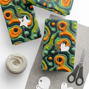 May include: Gift-wrapped boxes with a layered, abstract design in shades of green, orange, and yellow. Each box is tied with twine and adorned with a white tag. A ball of twine, scissors, and additional tags are also visible.