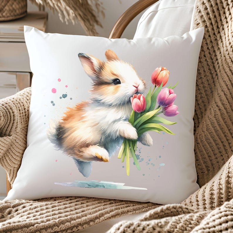 May include: A white pillow with a watercolor illustration of a brown and white bunny holding a bouquet of pink tulips.