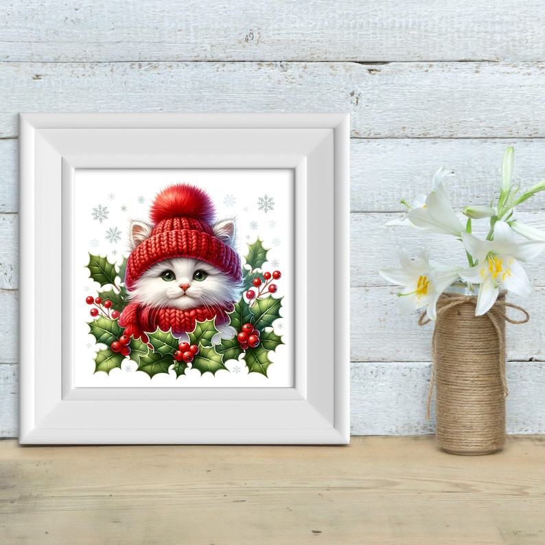 May include: A white cat wearing a red knit hat and scarf with a white pom pom on top of the hat. The cat is surrounded by holly leaves and red berries. The background is white with snowflakes.