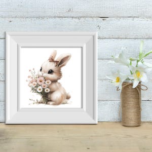 May include: A white rabbit with a pink bow holds a bouquet of white and pink flowers. The rabbit is sitting on a white background.