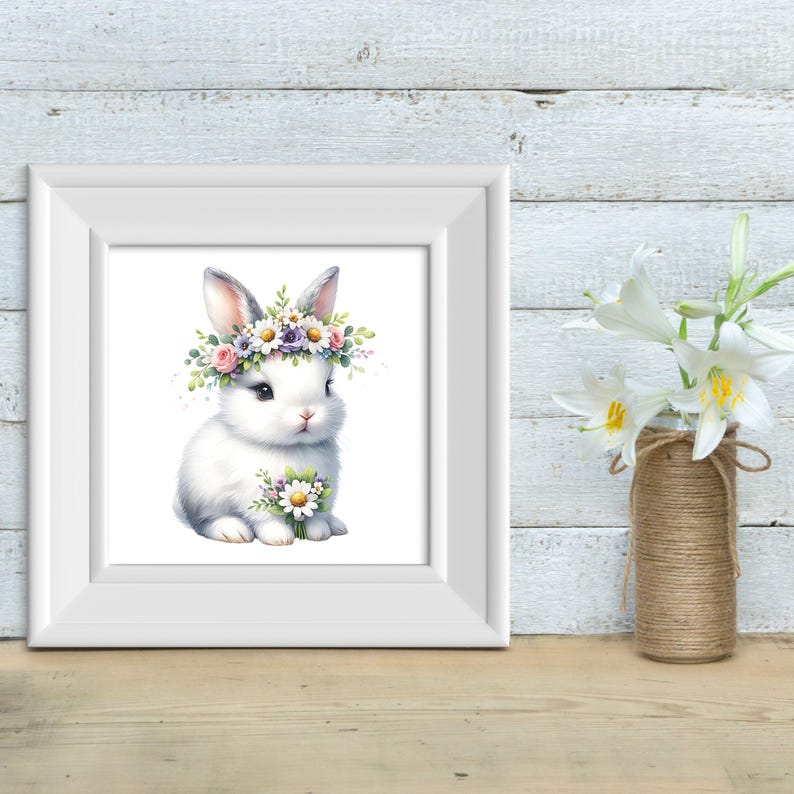 May include: A white bunny with a flower crown sits on a white background. The bunny is holding a bouquet of white flowers. The bunny has pink eyes and a pink nose.