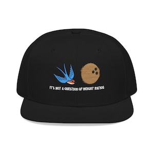 May include: Black baseball cap with embroidered design. Features a blue swallow and a brown coconut with three dark spots. The text "IT'S NOT A QUESTION OF WEIGHT RATIOS" is embroidered below the images.