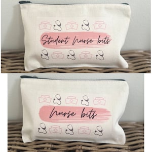 May include: Two white canvas zippered pouches with pink and black designs. The top pouch has the text "Student Nurse Bits" and the bottom pouch has the text "Nurse Bits". Both pouches have a pink watercolour-style background and are decorated with small black and pink nurse hats and stethoscopes.