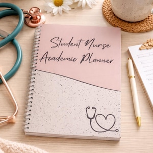 May include: A student nurse academic planner with a pink and white speckled cover. The text "Student Nurse Academic Planner" is written in black script. A stethoscope graphic is featured on the bottom section. A pen, coffee, and flowers are also visible.