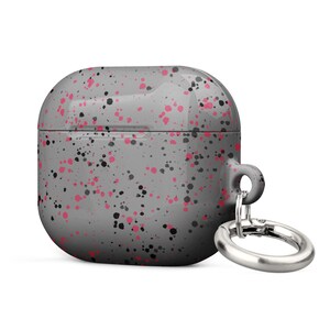May include: A grey and pink speckled silicone case for AirPods with a silver metal carabiner keychain.
