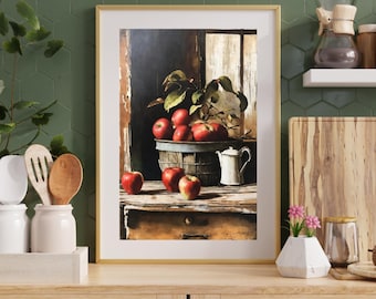 Puede incluir: Una lámina de arte enmarcada que muestra un bodegón de manzanas rojas en un cubo de metal rústico y sobre una mesa de madera, acompañada de una pequeña jarra blanca, sobre un fondo oscuro y evocador con un marco de ventana.