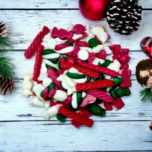 May include: A pile of red, white, and green candy canes, peppermint swirls, and other Christmas-themed candies.