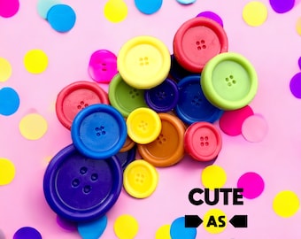 May include: A collection of colorful buttons arranged in a pyramid shape on a pink background. The buttons are various sizes and shapes, with some having a raised design. The text "Cute as Buttons" is written below the buttons.