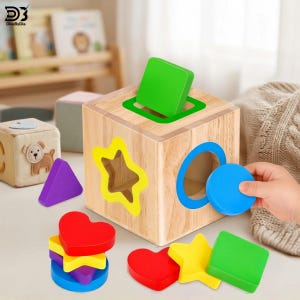 May include: A wooden shape sorting cube featuring cutouts in the shape of a star, circle, and square. The set includes colourful wooden blocks in red heart, yellow star, green square, blue circle, and purple triangle shapes for matching.