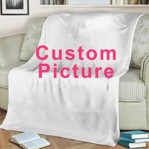 May include: White fleece throw blanket with the text "Custom Picture" in pink lettering.