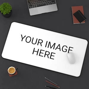 May include: A white desk mat with a black border. The text "YOUR IMAGE HERE" is printed in black on the mat. A white computer mouse is on the mat.