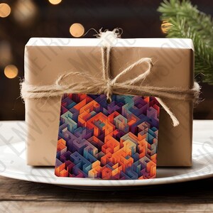 May include: A brown gift box with a colorful geometric pattern gift tag tied with twine. The box is sitting on a white plate on a wooden table. A small potted evergreen tree is in the background.