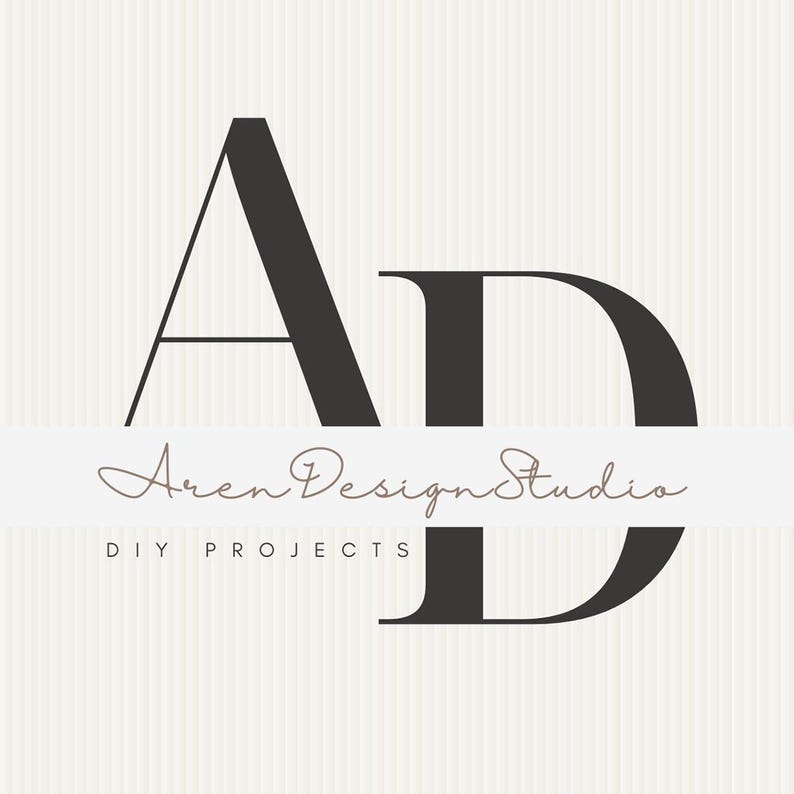 May include: A logo design featuring the letters "AD" in a bold, dark gray font. Below the letters, the words "Aren Design Studio" are written in a cursive font, with "DIY PROJECTS" below in a smaller, sans-serif font. The background has a vertical striped pattern.