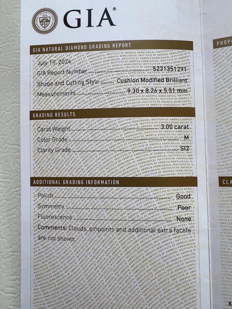 May include: A GIA diamond grading report for a 3.00 carat cushion modified brilliant diamond. The report details the diamond's measurements, colour grade, clarity grade, polish, symmetry, fluorescence, and comments. The report number is 5231351291.