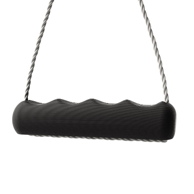 May include: A black exercise handle with a textured grip, suspended by two gray ropes. The handle has a curved, ergonomic design. The ropes are tightly wound, and the background is plain white.