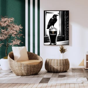 May include: Black and white illustration of a raven perched on top of a glass of Guinness beer. The raven is looking to the right. The glass of beer is in front of a window with brick walls on either side.