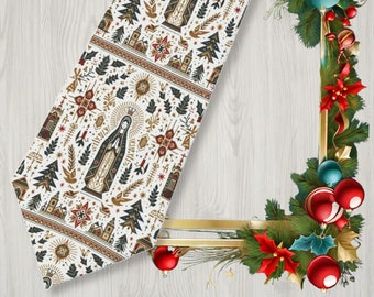 May include: A white table runner with a repeating pattern of religious figures, trees, and stars in brown, black, and red. The runner is decorated with a Christmas wreath and ornaments.